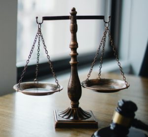 Scales of justice and gavel on a table top.