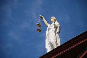 Scales of justice against blue sky.