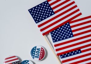US flags and vote buttons.