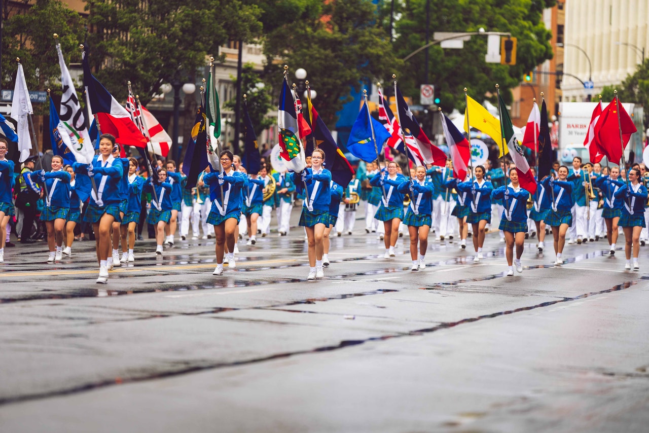 Image of dancing band with flags. I-9 Form Compliance Immigration Visa Attorney